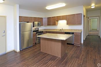 A kitchen with an island and stainless steel appliances